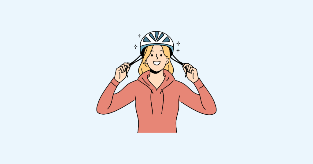 自転車用ヘルメットを被る女性