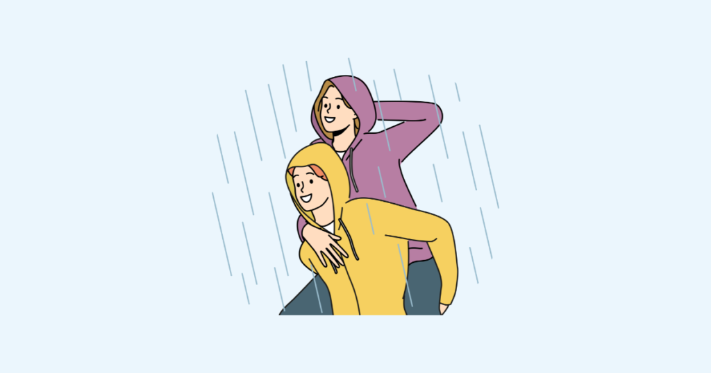 雨のなかでかっぱを着る男女
