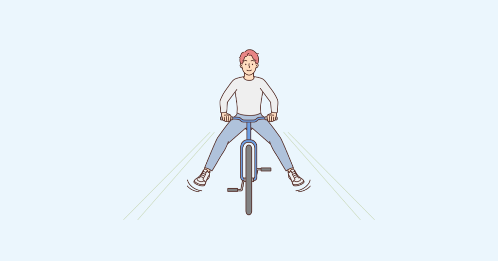自転車で坂道を下る男性